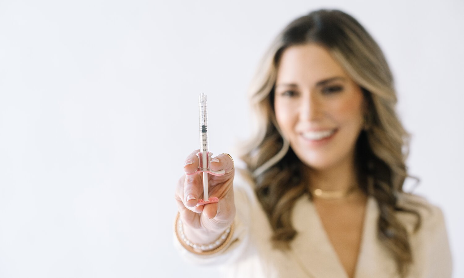 Aesthetic injector holding a filled syringe